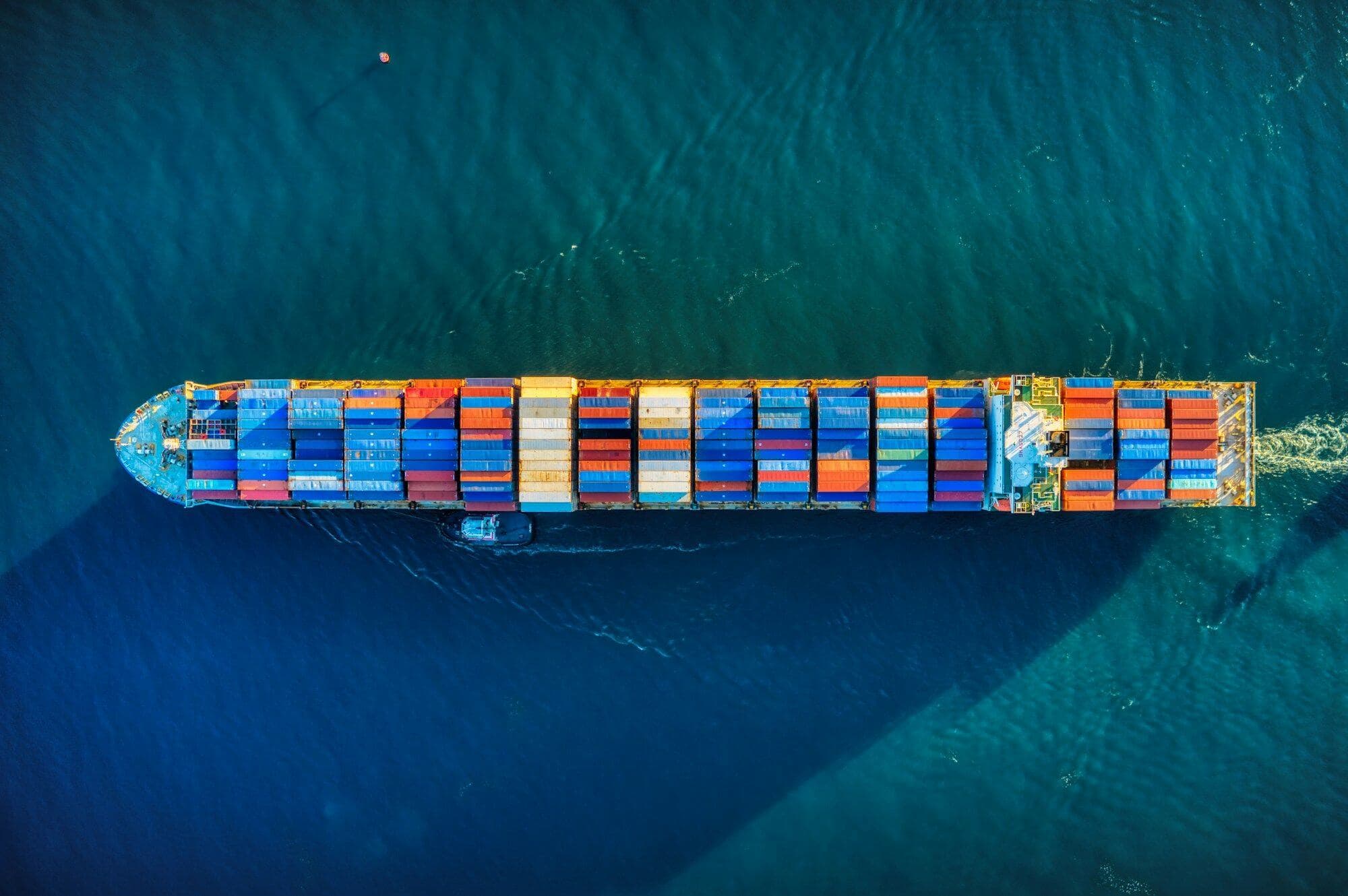 Top-down view of a fully loaded container ship at sea