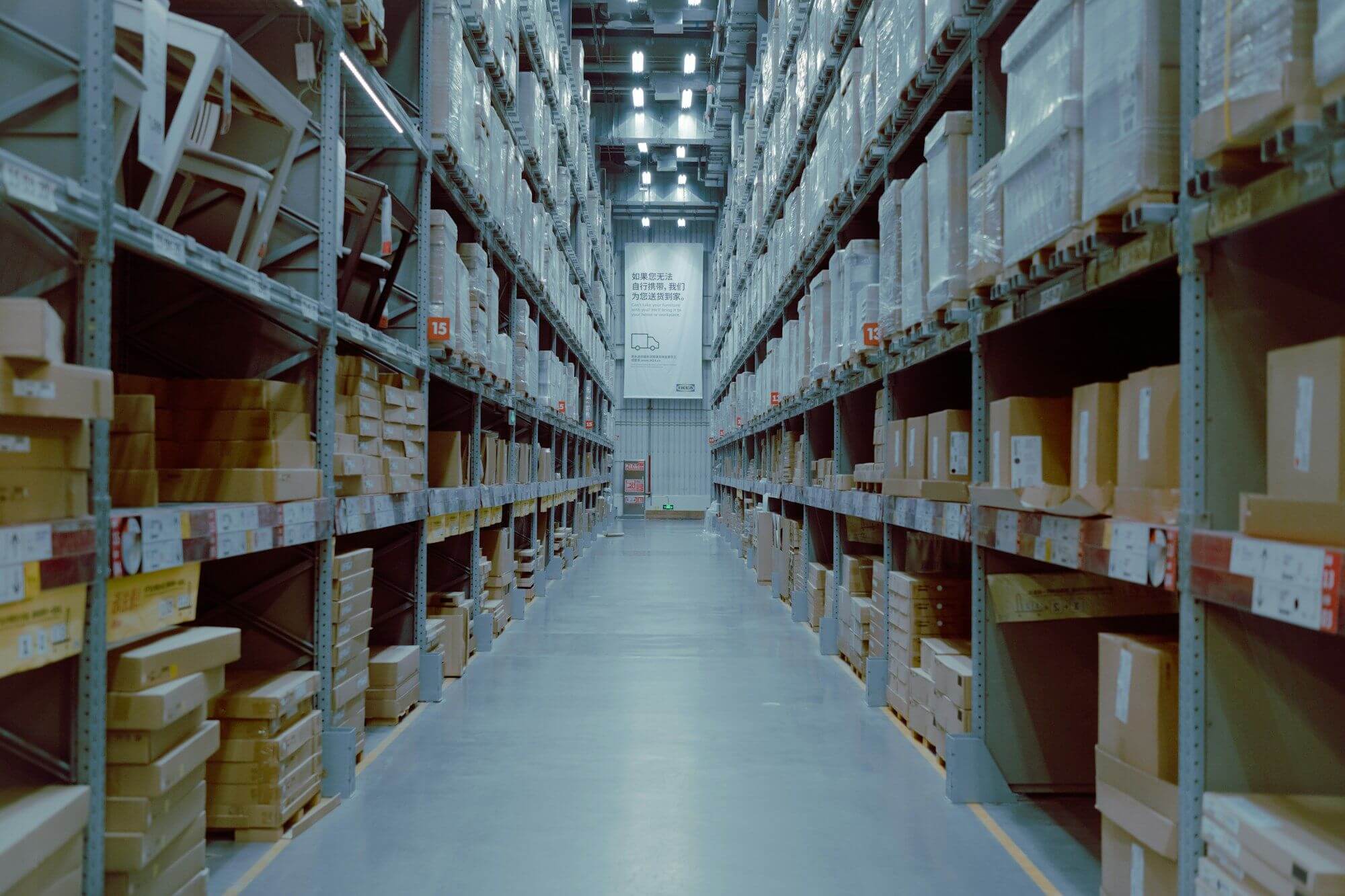 Warehouse aisle lined with racks of cartons